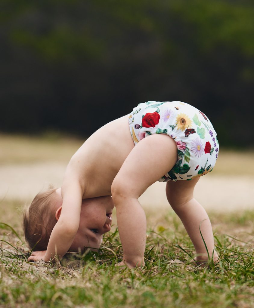 baby in cloth nappy with flowers on it